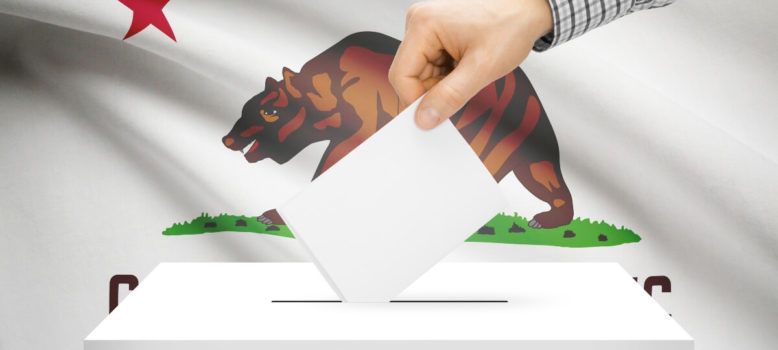 Image of a voting box in front of California state flag