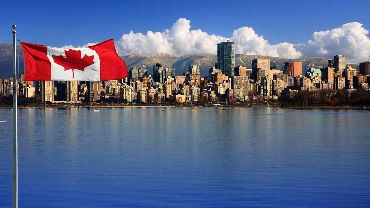 Image of Canadian flag with Vancouver, British Columbia in the background