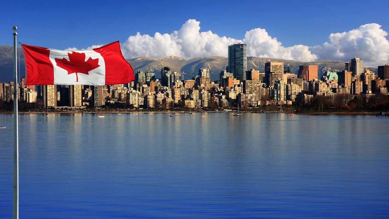 Image of Canadian flag with Vancouver, British Columbia in the background