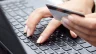 Image of an online shopper keying in credit card number