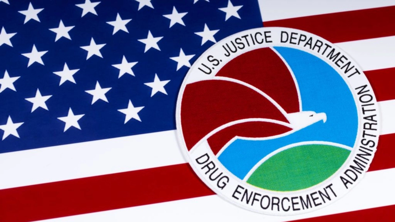 Image of Drug Enforcement Administration logo sitting atop a U.S. flag