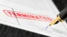 Image of employee signing a termination letter