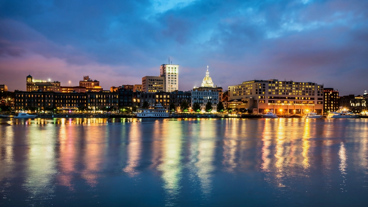 Image of downtown Savannah, Georgia, along riverfront at night. 