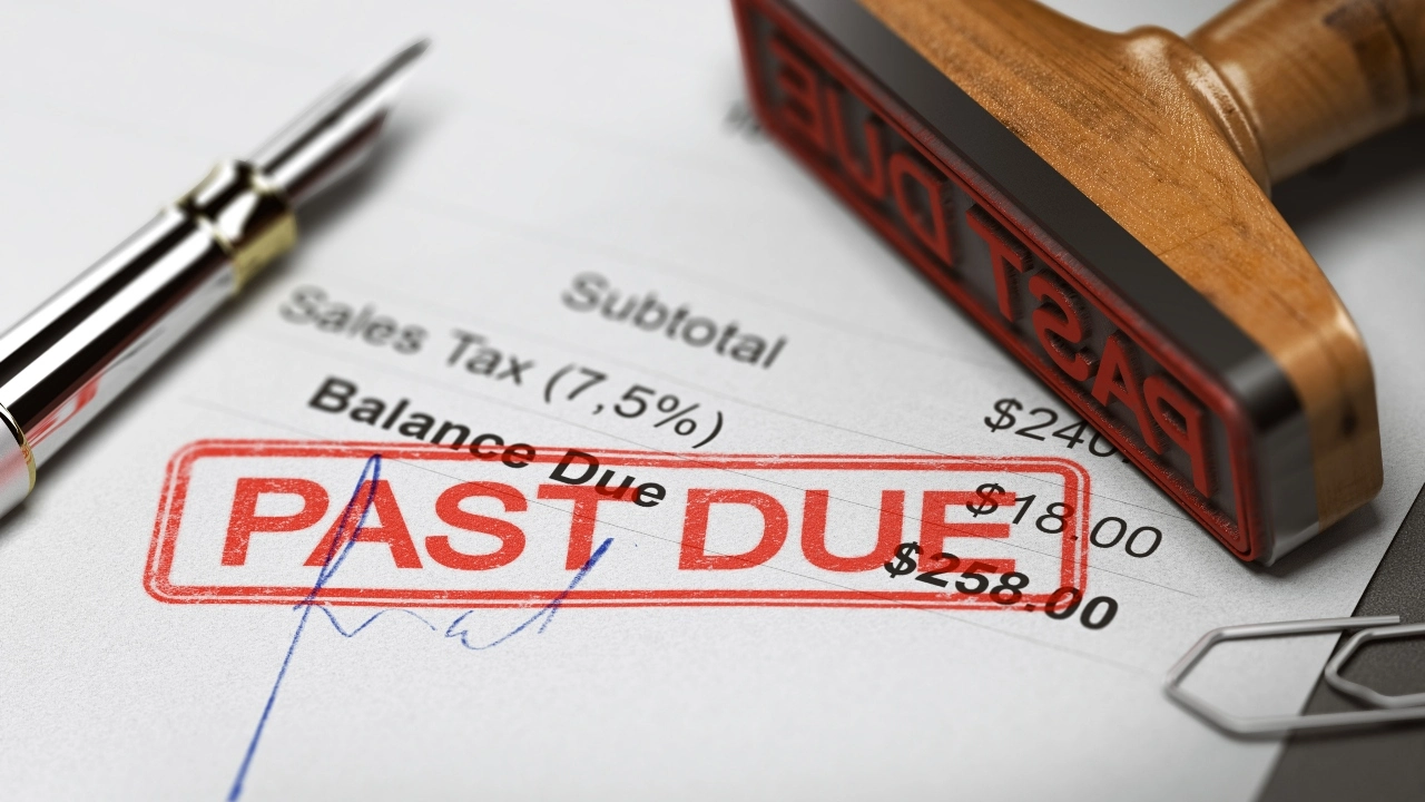 Image of a pen and Past Due stamp sitting atop a payment voucher