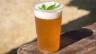 Image of a cup of beer with a cannabis leaf on top