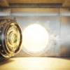 Image of an open bank vault door with gold light shining through