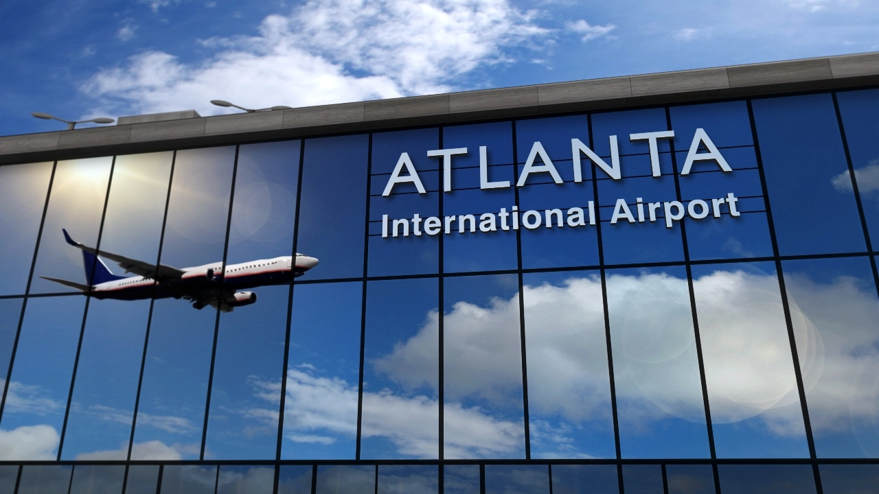 Image of an airline reflecting off a glass facade at the Atlanta airport 
