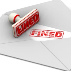 Image of a rubber stamp sitting atop an open envelope bearing the word 