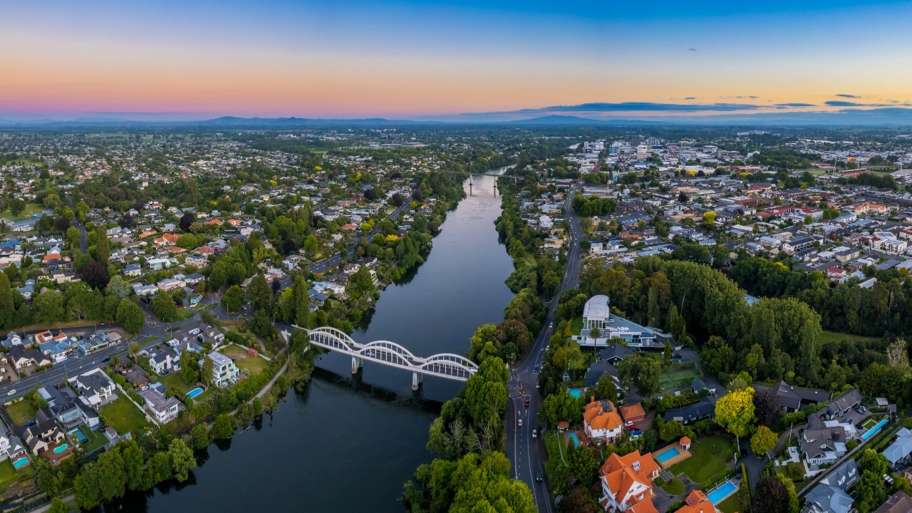 Aerial image, at sunset, over the city of Hamilton, New Zealand, looking up the Waikato River