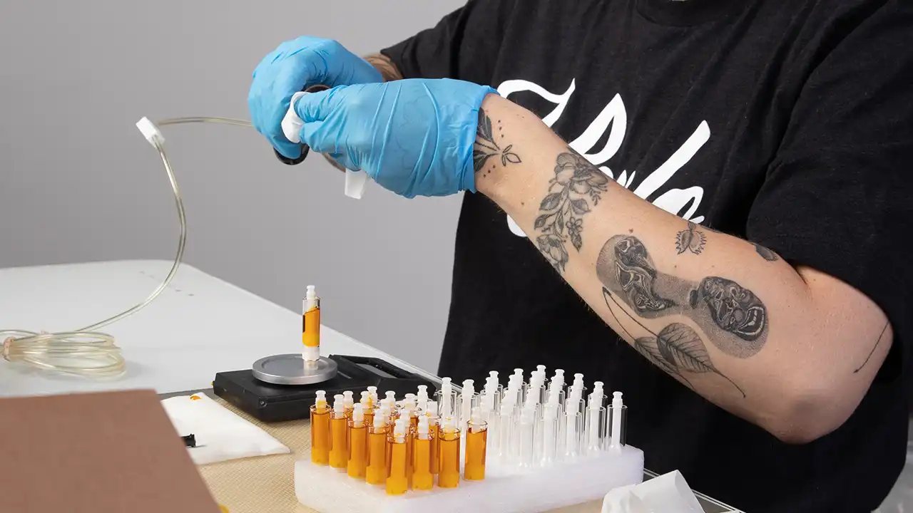 Image of employee filling vape cartridges at Heylo Cannabis in Seattle