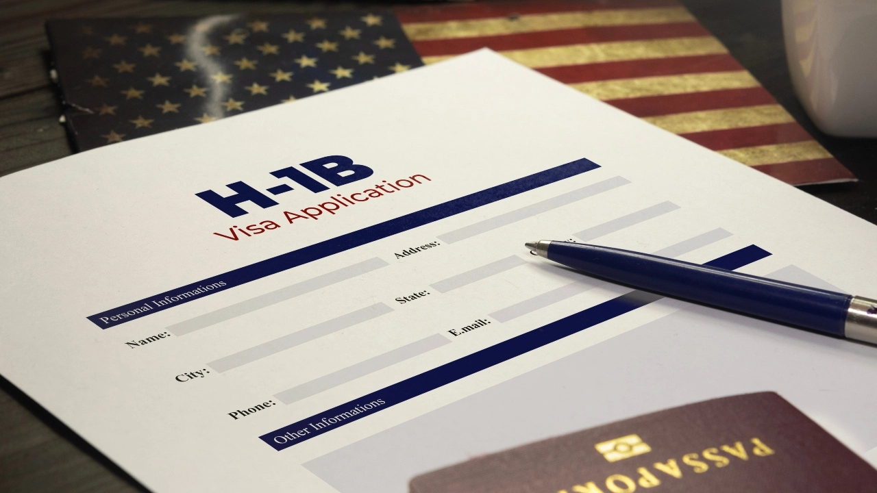 Image of an H-1B visa application on a table with a passport and pen nearby