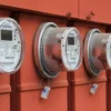 Photo of electric power meters on red electrical panels