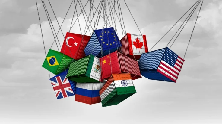 Image of freight containers, suspended by cables, representing U.S. tariffs on Canada, China, India and European Union nations