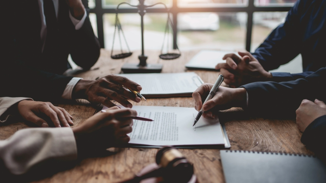 Image of businesspeople and attorneys negotiating terms of a contract 