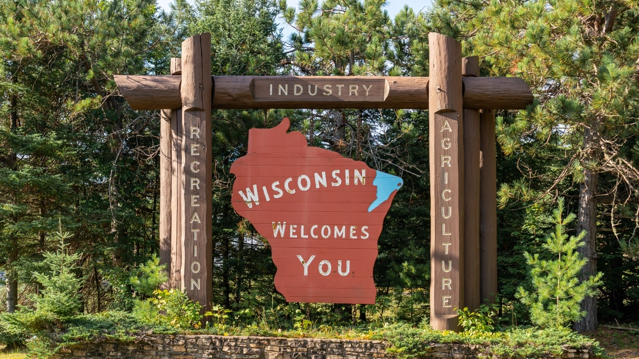 Image of a wood sign inscribed, Wisconsin Welcomes You
