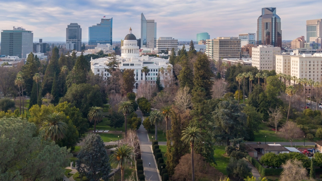 Image of the California state capitol building with downtown Sacramento in the background