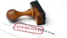 Inage of an APPROVED stamp lying on its side atop a trademark license application