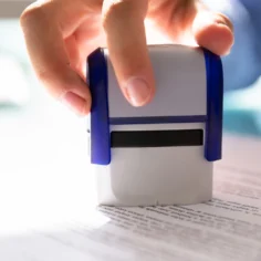 Image of a woman stamping approval on a business
