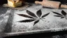 Image of a cannabis leaf formed in white flower with a rolling pin and dessert adjacent